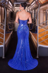 Model wearing a strapless fitted gown with plunging neckline, high side slit, and sparkling embellishments