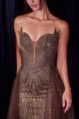 Espresso embellished strapless gown with an illusion plunge corset bodice, detachable glitter tulle overskirt, lace-up back, fitted silhouette, and sweeping train