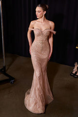 Woman wearing a sparkly off-shoulder gown against a dark background