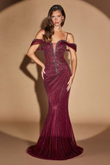 Woman wearing a burgundy evening gown with off-shoulder design on a beige background