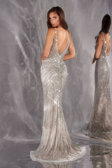 Woman wearing a sparkling silver evening gown against a gray background