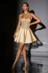 Model wearing a gold dress on a dark runway