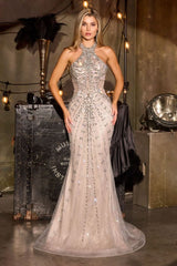 Woman in a sparkling evening gown standing in a stylishly decorated room with vintage props.