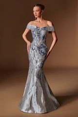 Woman wearing a silver and blue patterned off-shoulder gown against a brown background