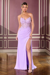 Woman wearing a lavender evening gown with a high slit in a room with decorative walls.