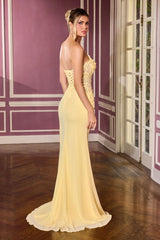 Woman in a yellow evening gown standing in a room with purple walls and wooden floor.