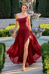 Woman in a red dress standing in front of a fountain