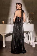 Woman in a black evening gown standing in front of a white grand piano with candles.