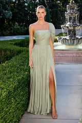 Woman in a light green strapless gown standing in front of a fountain
