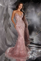 Woman wearing a pink beaded evening gown against a reflective surface.