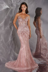 Woman wearing a pink beaded evening gown against a gray textured background