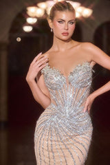 Woman wearing a sparkling evening gown with a dark background