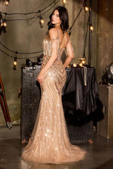 Woman in a sparkly gold dress standing in a stylish interior setting with string lights.