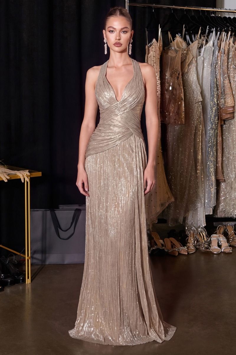 Champagne metallic pleated halter gown with a plunging neckline, draped bodice, lace-up corset back, and floor-length skirt.