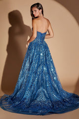 A woman modeling a strapless royal blue sequined ball gown from the back, set against a warm beige studio background with a soft shadow.