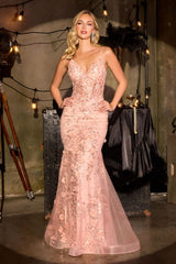 fitted gown showcases a delicate v-neckline and dimensional floral appliqué