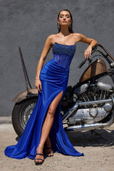 Model wearing a strapless gown featuring a beaded corset bodice, ruched waist detailing, and high side slit