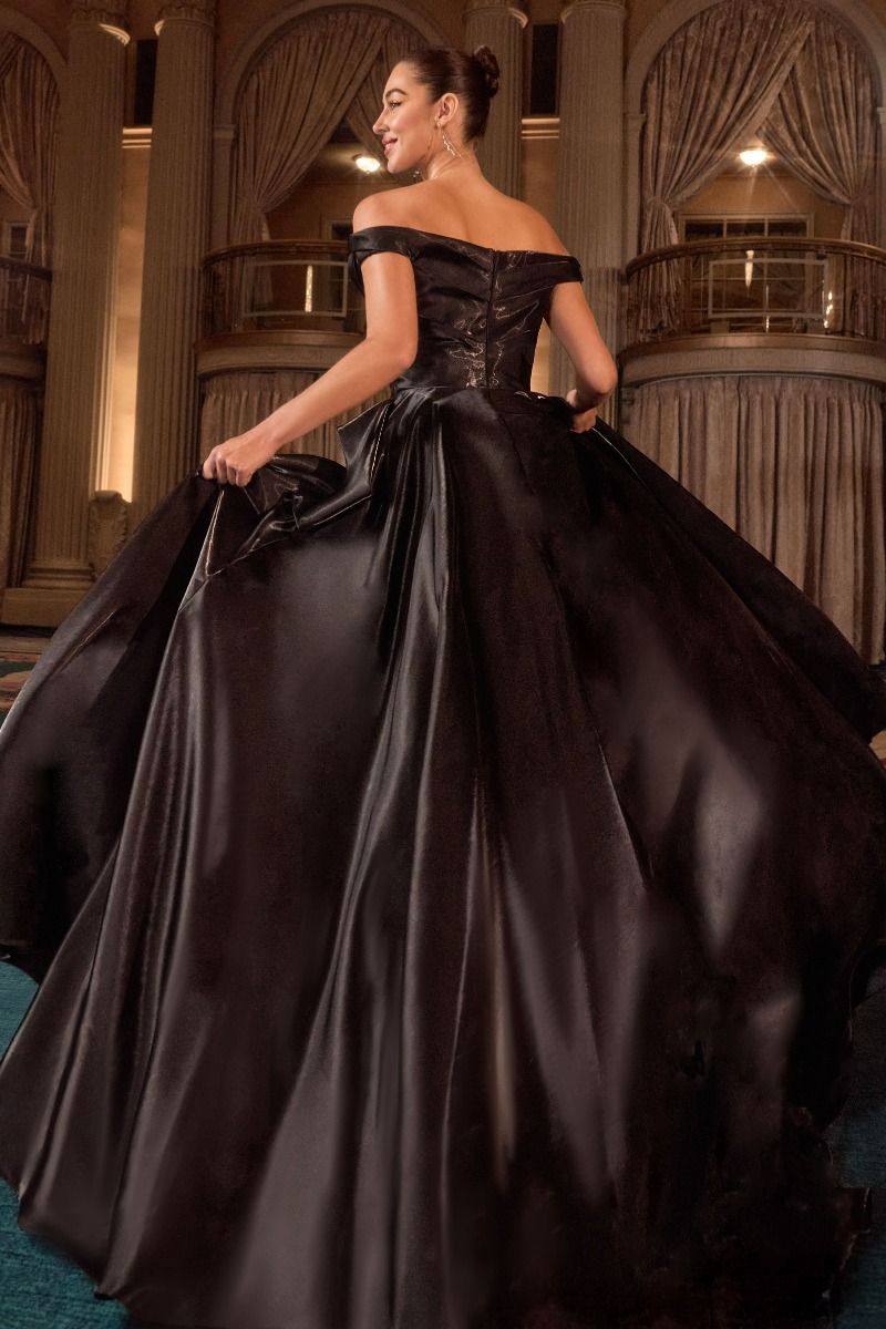 ball gown features an off-the-shoulder neckline and a pleated waistline
