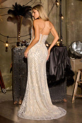 Woman in a sparkling evening gown standing in a stylishly decorated room with vintage decor.