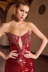 fitted gown showcases a daring deep illusion neckline and intricate crystal beading