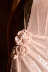 fitted gown stuns with its sleek strapless neckline and gleaming sequin finish