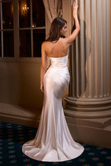 fitted satin dress, showcasing an asymmetrical strapless neckline and a beautifully pleated bodice