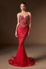 Woman wearing a red evening gown with intricate detailing on a brown background