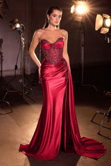 dress features an embellished, corset-style bodice with intricate detailing and a softly draped skirt that flows into a long train.
