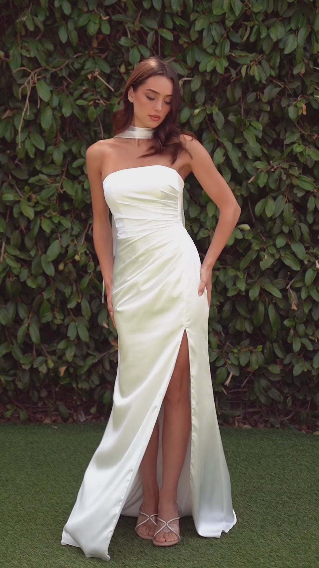 fitted strapless gown, crafted from luxe satin, features a sleek straight neckline, gathered waistline, and elegant leg slit
