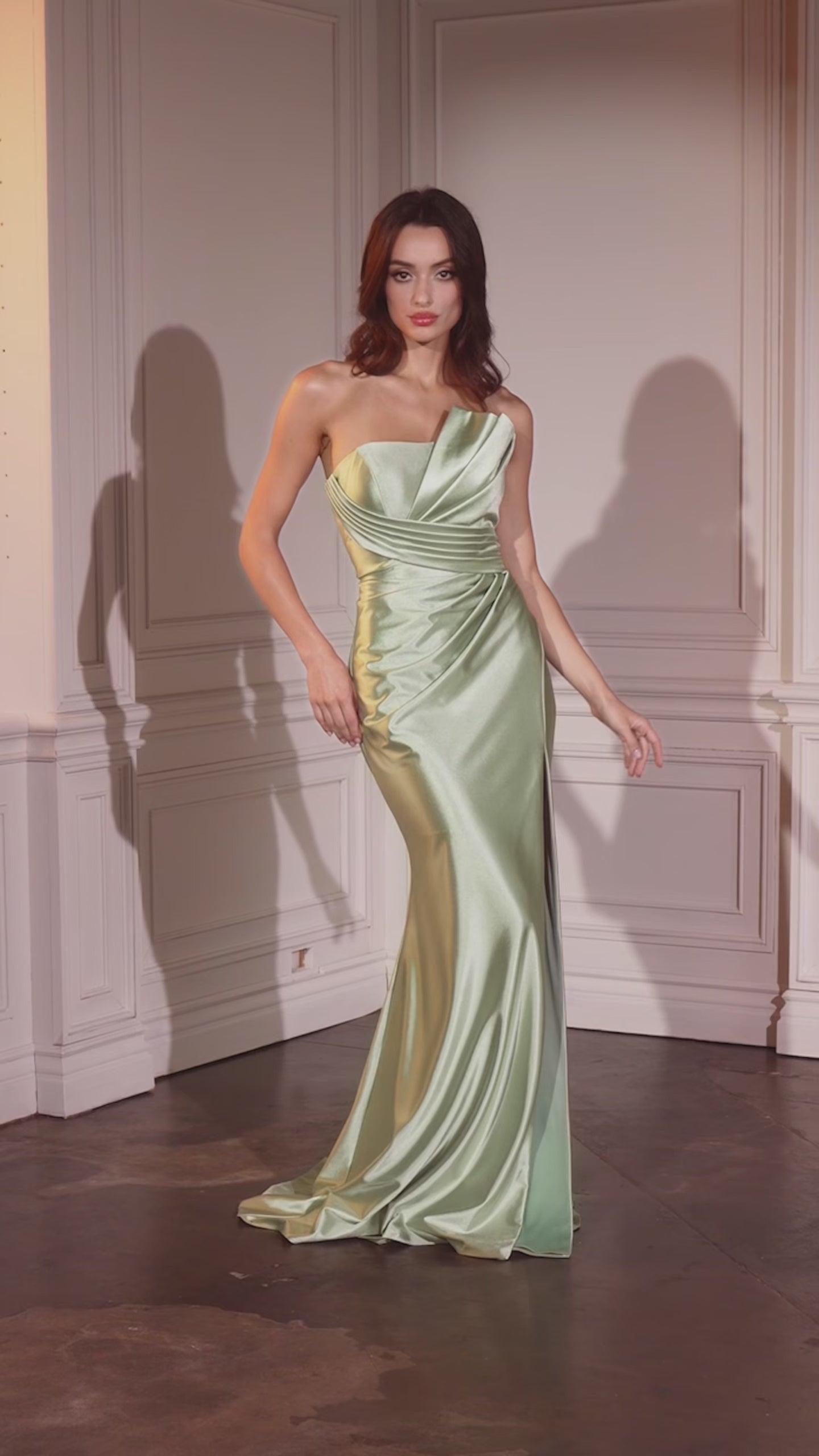 fitted satin dress, showcasing an asymmetrical strapless neckline and a beautifully pleated bodice