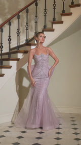 gown features a sleek fitted silhouette adorned with radiant beadwork arranged in sculptural, cascading lines