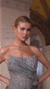 fitted gown captivates with its asymmetrical strapless neckline and hand-beaded embellishments