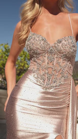 fitted gown is designed to captivate with its plunging neckline, thin straps, and a shimmering embellished bodice adorned with micro crystals