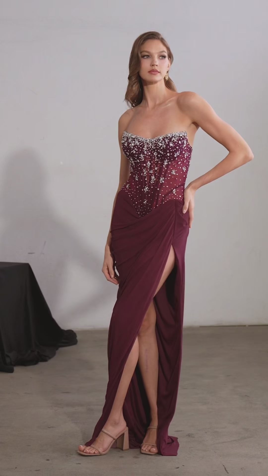 fitted gown featuring a strapless sheer corset bodice and shimmering beaded embellishments