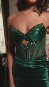 This fitted dress showcases a strapless sweetheart neckline and a sheer bodice adorned with intricate beading for an elegant touch