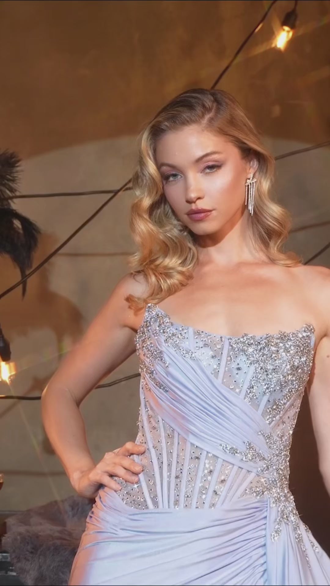 fitted gown captivates with its asymmetrical strapless neckline and hand-beaded embellishments