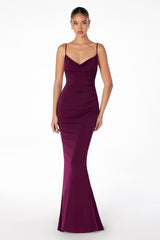 Woman wearing a purple evening gown on a white background