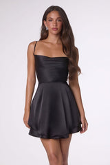 Woman wearing a black strapless dress on a white background
