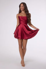 Woman wearing a red satin dress on a white background