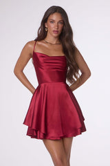 Woman wearing a red satin dress on a white background