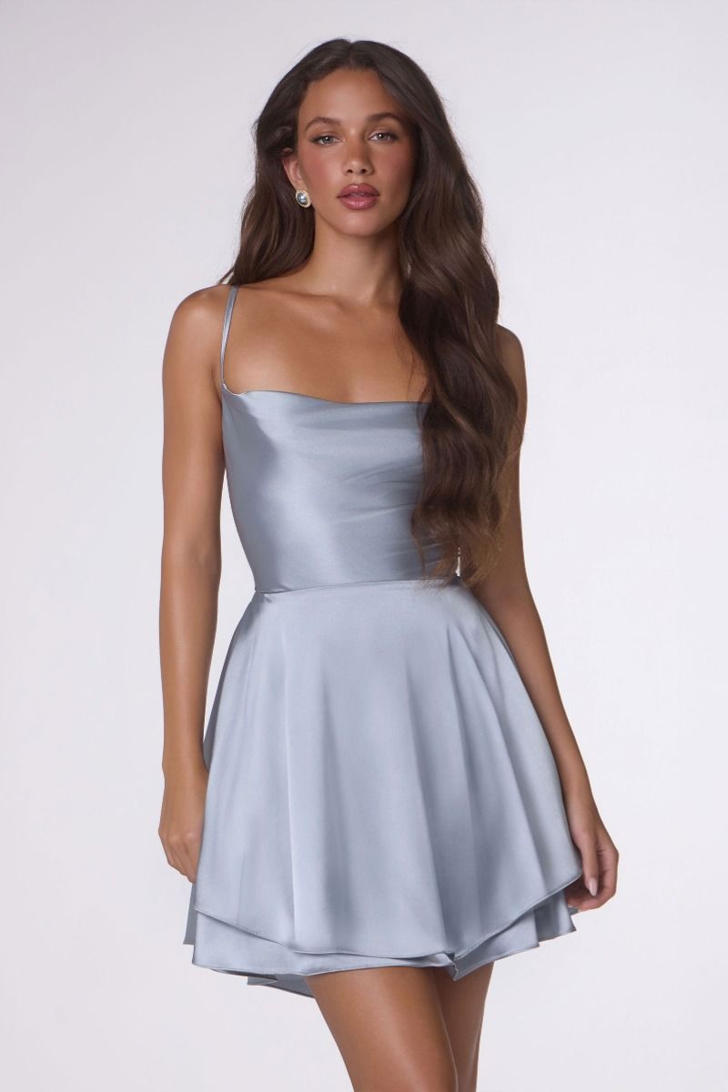Woman wearing a light blue dress against a white background