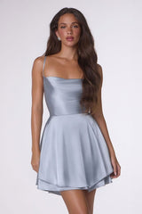 Woman wearing a light blue dress against a white background