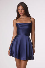 Woman wearing a navy blue dress on a white background