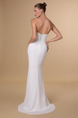 Woman wearing a white strapless gown with a beige background