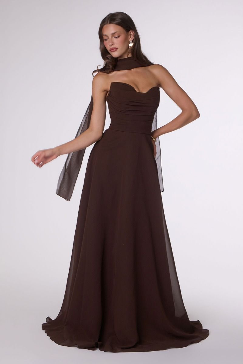 Woman wearing a brown strapless gown on a white background