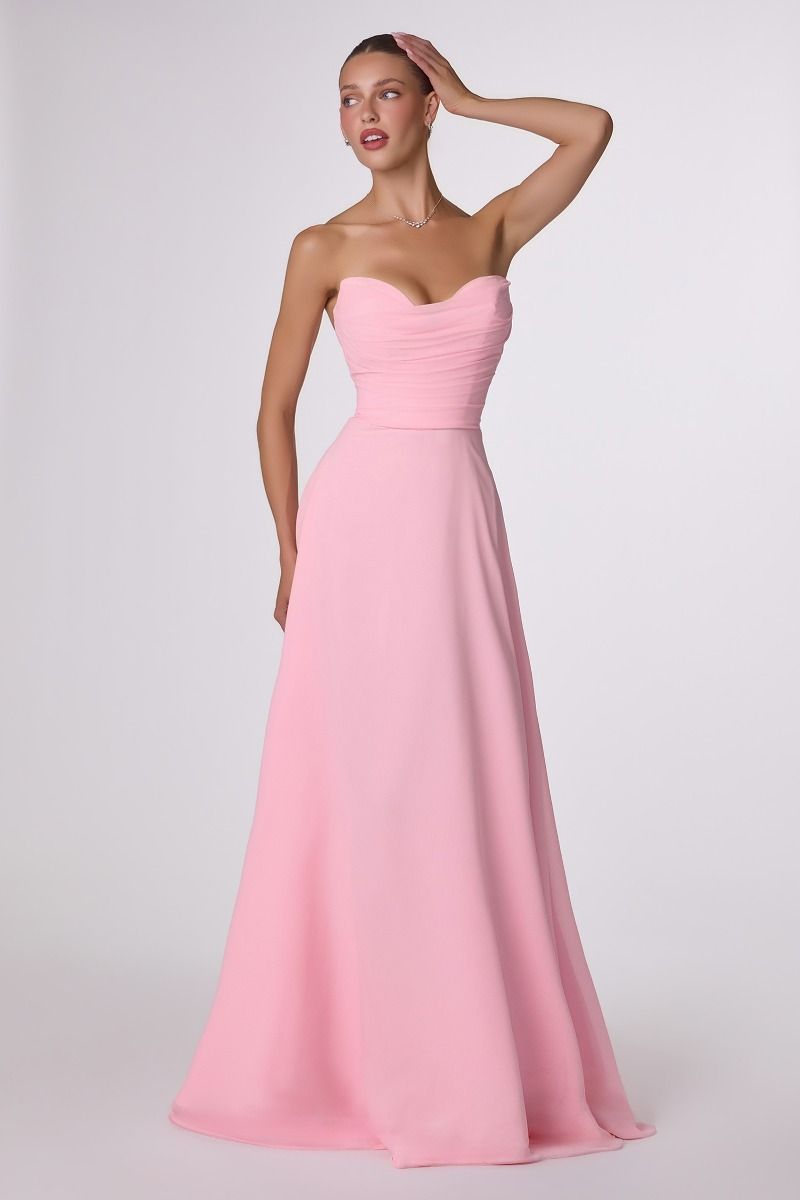 Woman wearing a pink strapless gown on a white background
