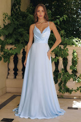 Model wearing a satin gown with draped cowl neckline, fitted waist, and floor-length skirt, featuring thin crisscross straps and open back