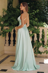 Model wearing a satin gown with draped cowl neckline, fitted waist, and floor-length skirt, featuring thin crisscross straps and open back