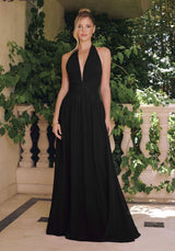 Model wearing a halter maxi dress featuring a plunging neckline, ruched waist, and flowing floor-length skirt