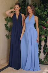 Model wearing a halter maxi dress featuring a plunging neckline, ruched waist, and flowing floor-length skirt